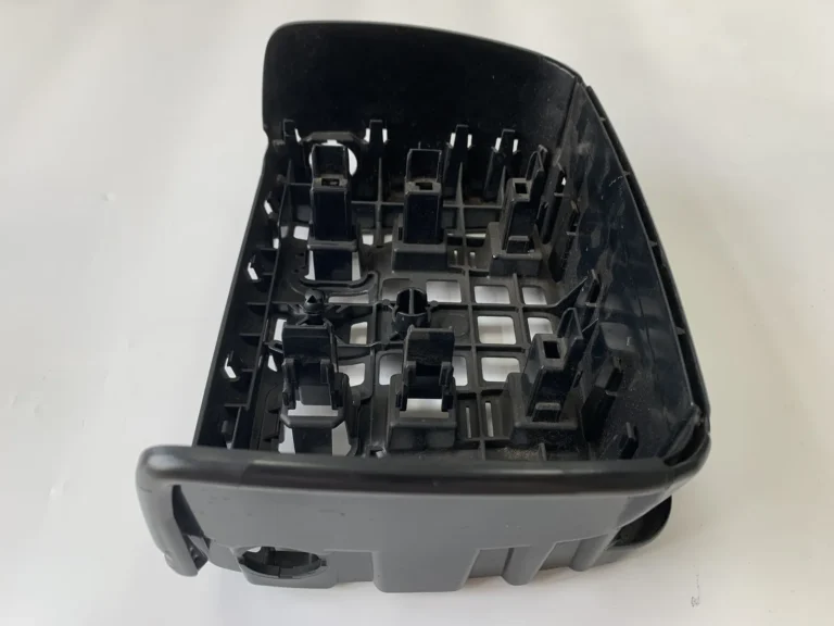 Moulded plastic housing with deep ribs and bosses, the geometry where abrasive fillers and recycled compounds show wear first