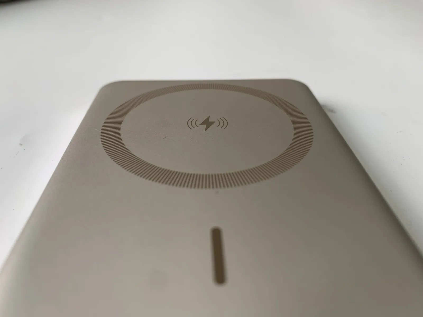 High-gloss moulded charging pad surface with a fine patterned ring, the finish that NAK80 and S136-class steels are chosen to hold